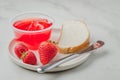 Strawberry jam. Making sandwiches with strawberry jam. Bread and strawberry jam on a white table with jar of jam and fresh Royalty Free Stock Photo