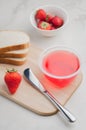 Strawberry jam. Making sandwiches with strawberry jam. Bread and strawberry jam on a white table with jar of jam and fresh Royalty Free Stock Photo