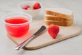 Strawberry jam. Making sandwiches with strawberry jam. Bread and strawberry jam on a white table with jar of jam and fresh Royalty Free Stock Photo