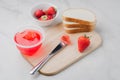 Strawberry jam. Making sandwiches with strawberry jam. Bread and strawberry jam on a white table with jar of jam and fresh Royalty Free Stock Photo