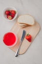 Strawberry jam. Making sandwiches with strawberry jam. Top view. Bread and strawberry jam on a white table with jar of jam and Royalty Free Stock Photo