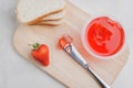 Strawberry jam. Making sandwiches with strawberry jam. Top view. Bread and strawberry jam on a white table with jar of jam and Royalty Free Stock Photo