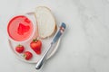 Strawberry jam. Making sandwiches with strawberry jam. Top view, copyspace. Bread and strawberry jam on a white table with jar of Royalty Free Stock Photo