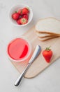 Strawberry jam. Making sandwiches with strawberry jam. Top view. Bread and strawberry jam on a white table with jar of jam and Royalty Free Stock Photo