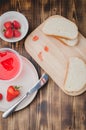 Strawberry jam. Bread and strawberry jam on a wooden table with jar of jam and fresh strawberry. Top view. Making sandwiches with Royalty Free Stock Photo