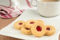 Strawberry jam sandwich biscuits with coffee cup