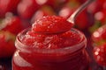 Strawberry jam. Spoon scooping homemade strawberry jam from a glass jar surrounded by fresh strawberries Royalty Free Stock Photo