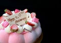 Strawberry jelly vanilla mousse cake with a white chocolate anniversary greeting card on the top Royalty Free Stock Photo