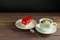 Strawberry jelly yogurt on the white plate and cup of black coffee on wooden table Royalty Free Stock Photo