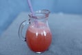 A glass jar of strawberry juice