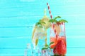 Strawberry juice and lemon juice mixing soda no alcohol in the glass garnish with mint leaves, sliced lime on blue wooden table Royalty Free Stock Photo