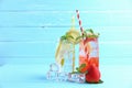 Strawberry juice and lemon juice mixing soda no alcohol in the glass garnish with mint leaves, sliced lemon on blue wooden table Royalty Free Stock Photo