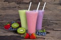 Strawberry kiwi and blueberry smoothies juice,beverage healthy the taste yummy In glass,drink episode morning on wooden background