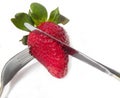 Strawberry with a knife and fork
