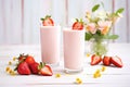 strawberry lassi in tall glasses, fresh strawberries beside