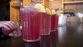 Strawberry lemonade on a dark wooden bar table in retro glasses. Party time concept. Selective focus. Copy space. Royalty Free Stock Photo