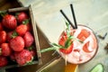 Strawberry lemonade with lime and ice in mason jar on a wooden table jpg Royalty Free Stock Photo