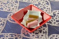 Strawberry and licorice caramels in candy wrappers