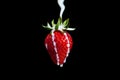 Strawberry Making A Splash. Isolated on black background. Royalty Free Stock Photo