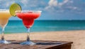 strawberry margarita and Daiquiri frozen and on ice with lime and berry fruit at beach side for summer time relaxation in the sun Royalty Free Stock Photo