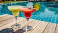 strawberry margarita and Daiquiri frozen and on ice with lime and berry fruit at pool side for summer time relaxation in the sun Royalty Free Stock Photo