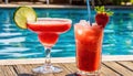 strawberry margarita and Daiquiri frozen and on ice with lime and berry fruit at pool side for summer time relaxation in the sun Royalty Free Stock Photo