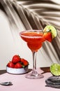 Strawberry Margarita summer cocktail drink with silver tequila, lime juice, liqueur, fresh berries and ice in glass with salt rim Royalty Free Stock Photo