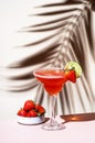 Strawberry Margarita summer cocktail drink with silver tequila, lime juice, liqueur, fresh berries and ice in glass with salt rim Royalty Free Stock Photo