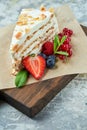 Strawberry meringue cake with almond petals, on newspaper Royalty Free Stock Photo