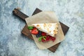 Strawberry meringue cake with almond petals, on newspaper Royalty Free Stock Photo