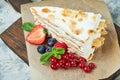 Strawberry meringue cake with almond petals, on newspaper Royalty Free Stock Photo