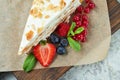 Strawberry meringue cake with almond petals, on newspaper Royalty Free Stock Photo