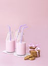 Strawberry milk and cookies on pink