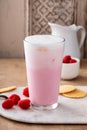 Strawberry milk drink with cold foam in a tall glass