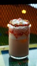 Strawberry milk drink with marshmallow topping and sweet colored sugar candy