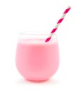 Strawberry milk in a glass tumbler with straw over white