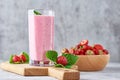 Strawberry milk shake in a glass jar and fresh strawberries with leaves Royalty Free Stock Photo