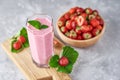 Strawberry milk shake in a glass jar and fresh strawberries with leaves Royalty Free Stock Photo