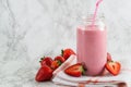 Strawberry milkshake in the glass jar on the table Royalty Free Stock Photo