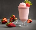 Strawberry milkshake, smoothie cocktail glass, ice cream ball and fresh srawberries gray background Royalty Free Stock Photo