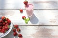 Strawberry milkshake on white wooden table with fresh strawberries at the background. Royalty Free Stock Photo