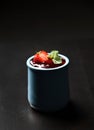 Strawberry and mint desert of fresh ripe  homemade yogurt pana cotta in blue jar on dark background Royalty Free Stock Photo