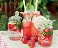 Strawberry and mint infused detox water. strawberry lemonade with ice and mint as summer refreshing drink in jars. Cold soft Royalty Free Stock Photo