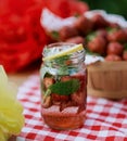 Strawberry and mint infused detox water. strawberry lemonade with ice and mint as summer refreshing drink in jars. Cold soft Royalty Free Stock Photo