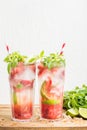 Strawberry mojito summer cocktails with mint and lime in tall glasses Royalty Free Stock Photo