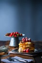 Strawberry pancakes with maple syrup.Sprinkle with powdered sugar on top.