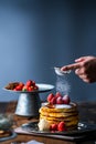 Strawberry pancakes with maple syrup.Sprinkle with powdered sugar on top.