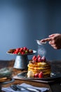 Strawberry pancakes with maple syrup.Sprinkle with powdered sugar on top.