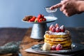 Strawberry pancakes with maple syrup.Sprinkle with powdered sugar on top.