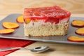 Strawberry and peach cake with gelatin on grey plate on wooden t Royalty Free Stock Photo